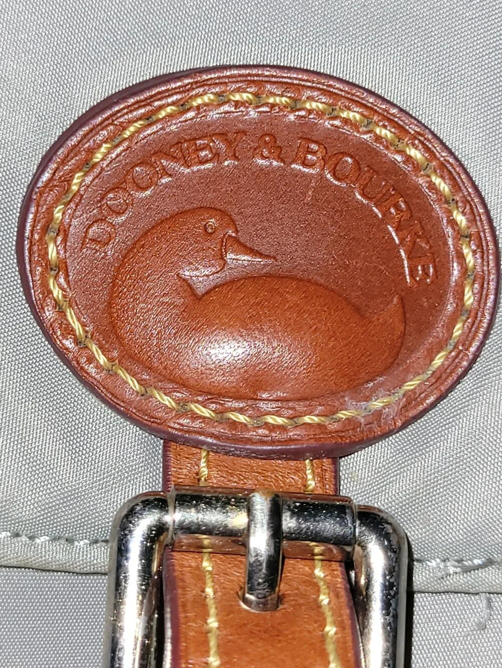 Dooney & Bourke Light Gray Nylon Backpack with Brown Leather Trim.